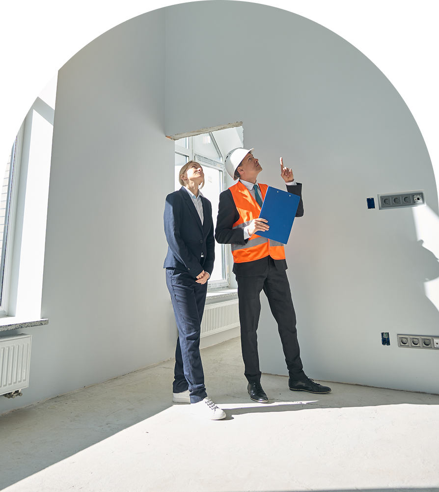 GettyImages-2158653629 Two people inspecting a room construction.